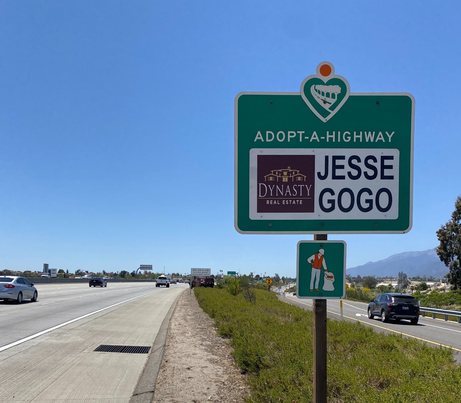 Jesse Gogo Adopt-A-Highway sign on the SR-210 shoulder near the Pepper Avenue exit on a clear day.