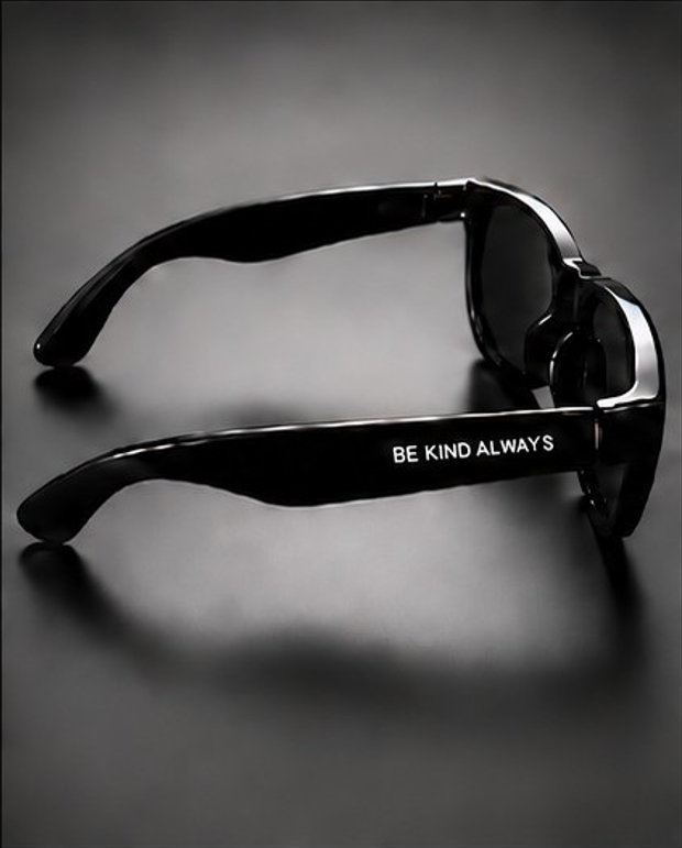 Black sunglasses side view with BE KIND ALWAYS printed on the arm.